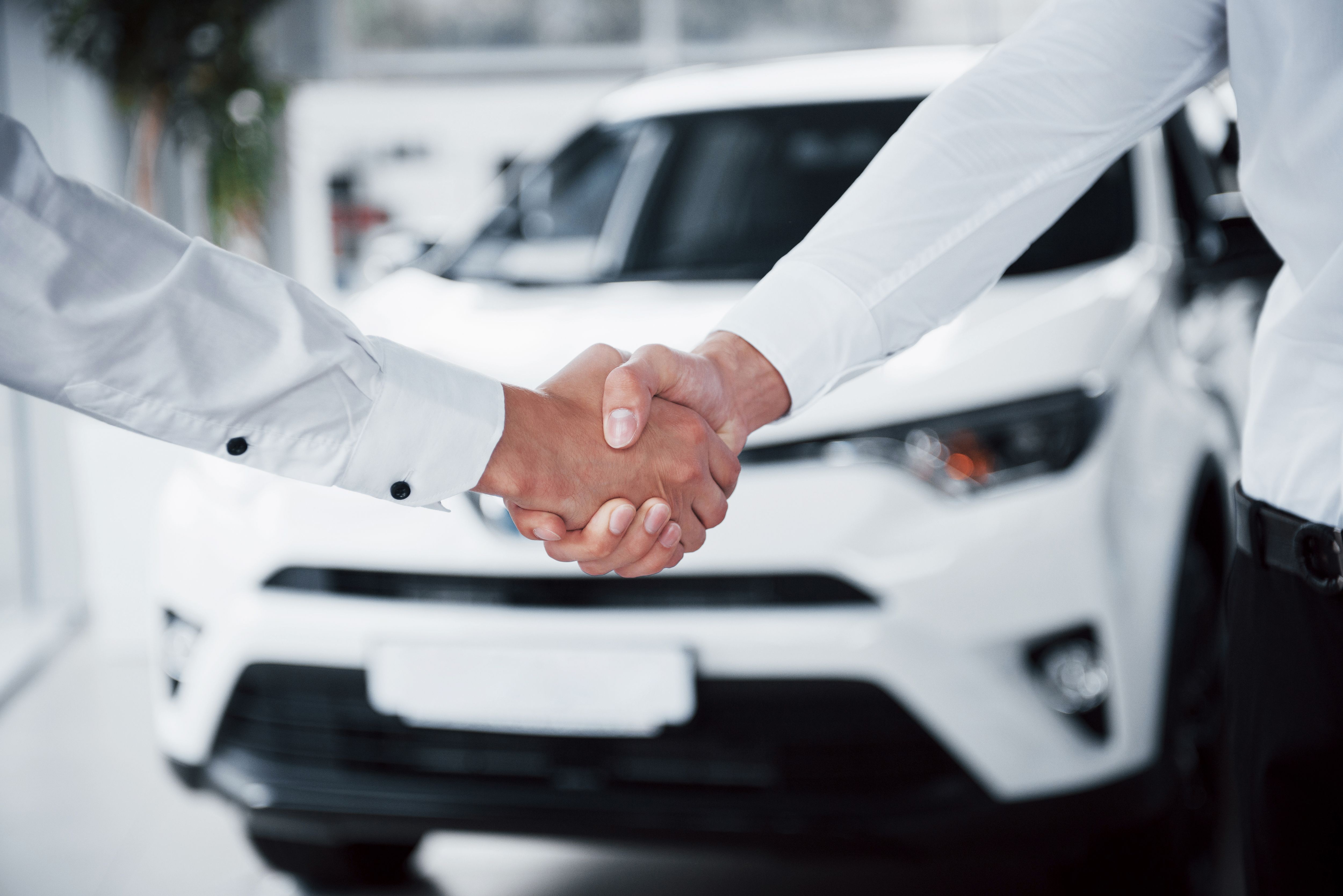 close-up-sales-manager-black-suit-selling-car-customer.jpg